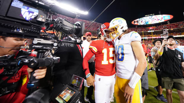 Sep 15, 2022; Kansas City, Missouri, USA; Los Angeles Chargers quarterback Justin Herbert (10) meets with Kansas City Chiefs quarterback Patrick Mahomes (15) following the game at GEHA Field at Arrowhead Stadium. Mandatory Credit: Jay Biggerstaff-USA TODAY Sports